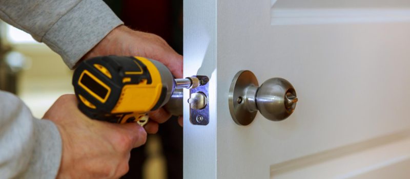 carpenter-install-door-lock-using-screwdriver-home-installation-locks-door