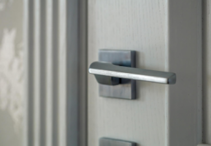 closeup-metal-handle-door-blurred-background