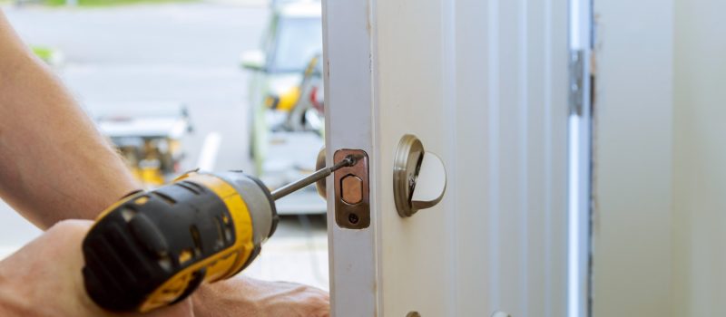 man-repairing-doorknob-closeup-worker-s-hands-installing-new-door-locker